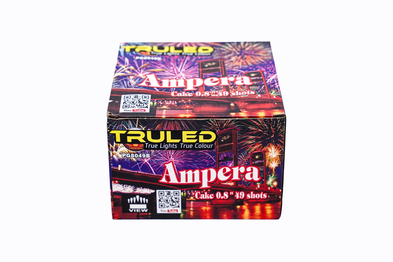 Close-up of a colorful fireworks box labeled 'Ampera' with fireworks graphics and QR codes on the front edge.