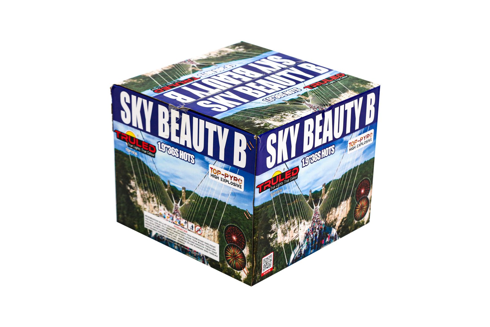 Box of fireworks labeled SKY BEAUTY B on blue packaging with images of aerial launches and mountains in the artwork.