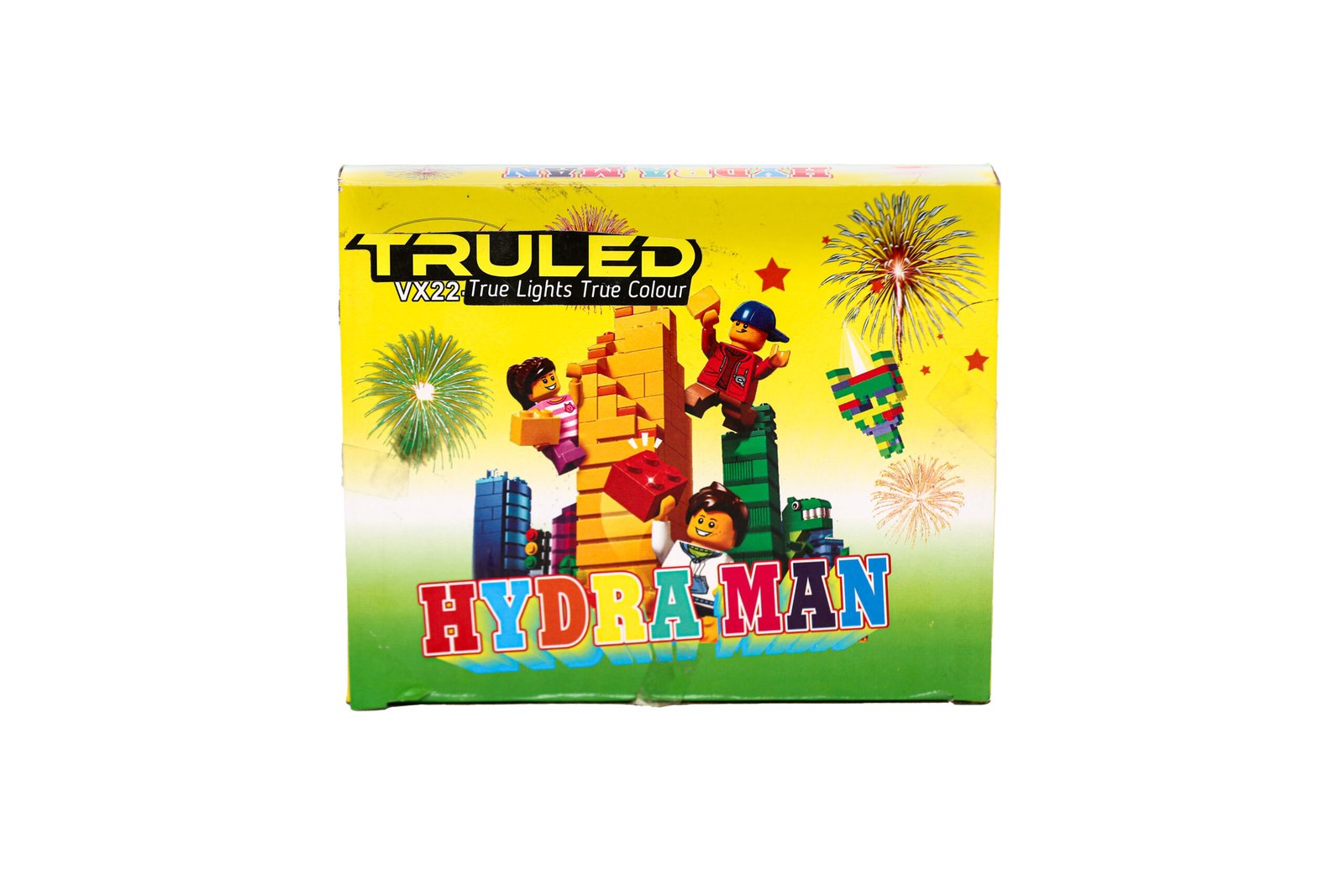 Bright yellow toy box cover showing lego-style figures building a brick tower with fireworks in the background and 'HYDRA MAN' text at the bottom.