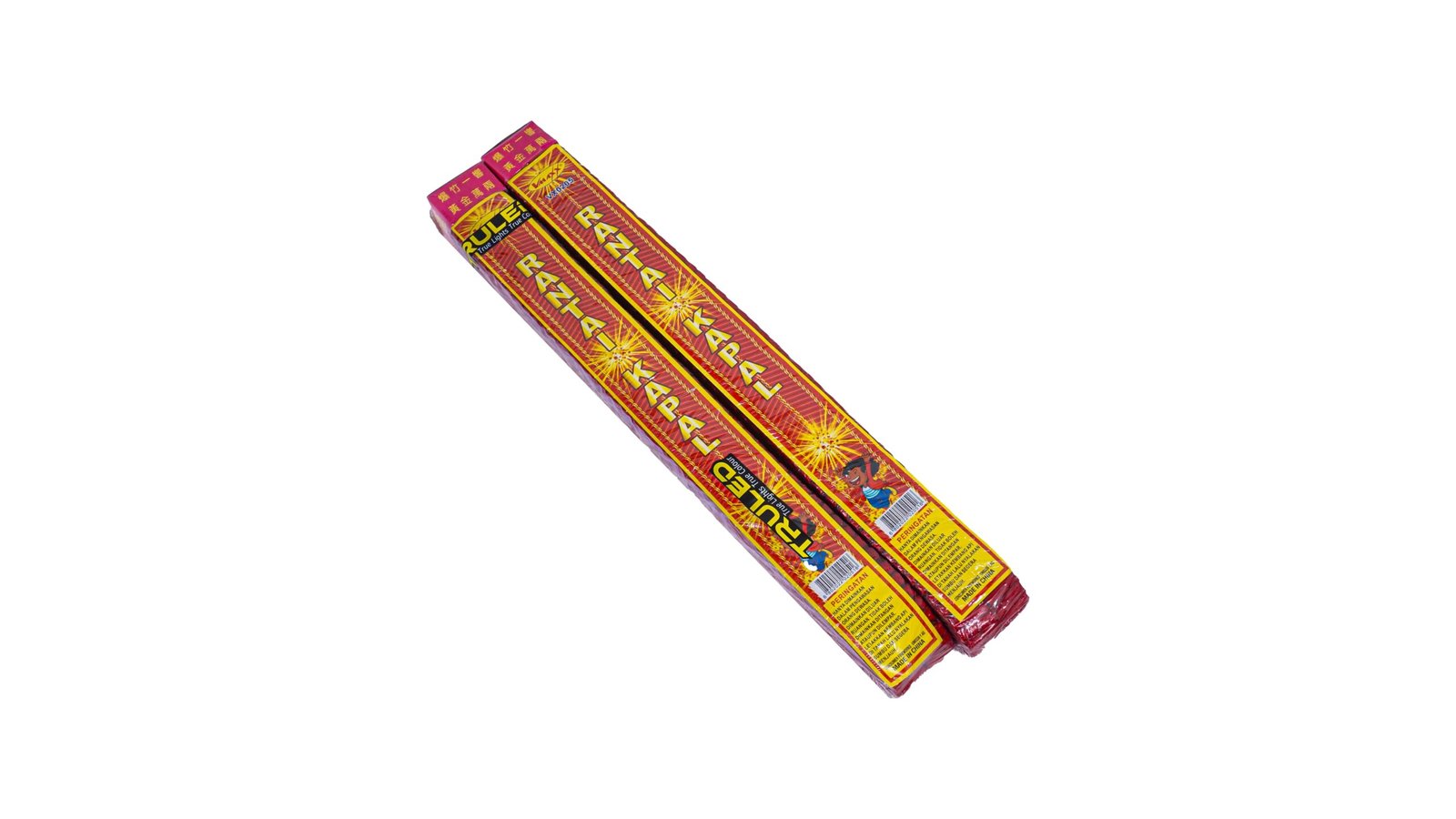 Two red-and-yellow fireworks rocket packs laid diagonally with warning labels.