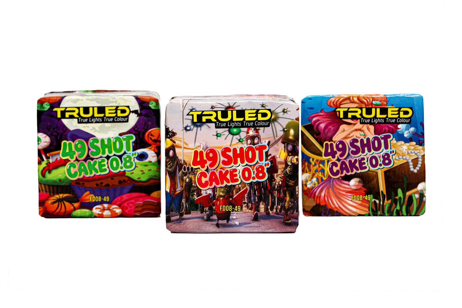 Three bright TRULED fireworks cake boxes lined up, each with colorful artwork and the text '49 SHOT CAKE 0.8' and 'True Lights True Colour'